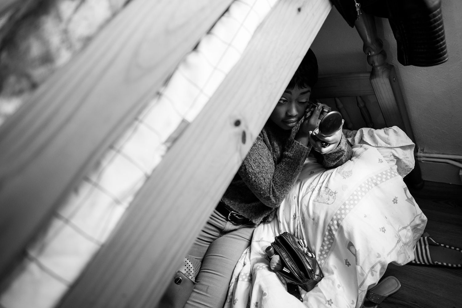 Documentary style black and white photo of studio photography preparation.