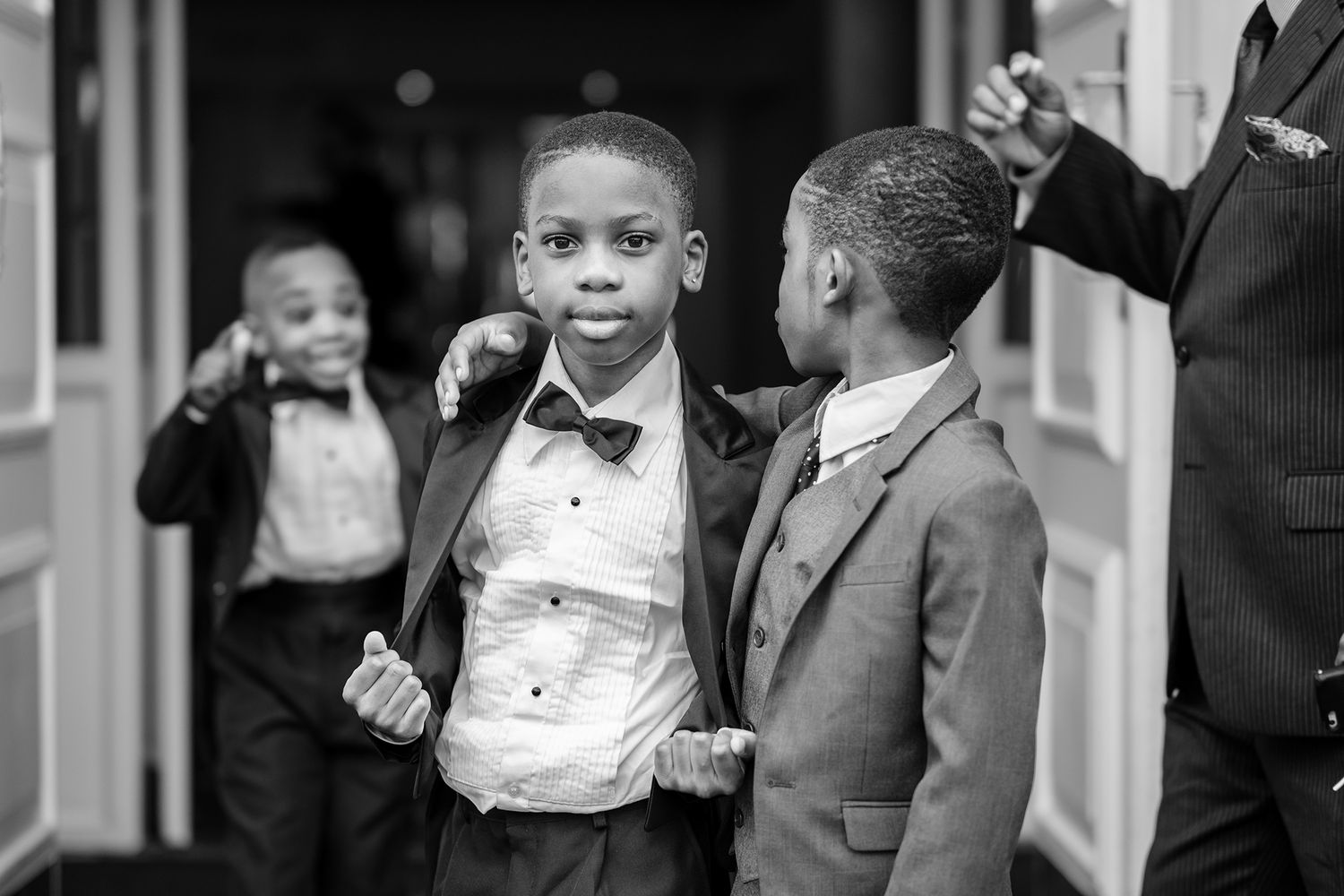 Children in formal wear posing at an elegant wedding celebration.