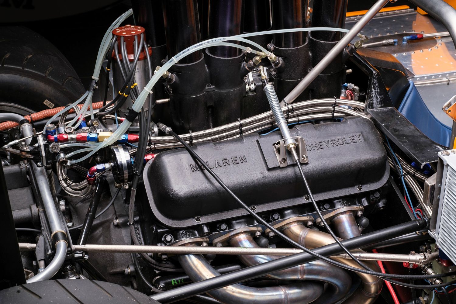 Close-up view of car engine components and wiring harnesses under the hood.