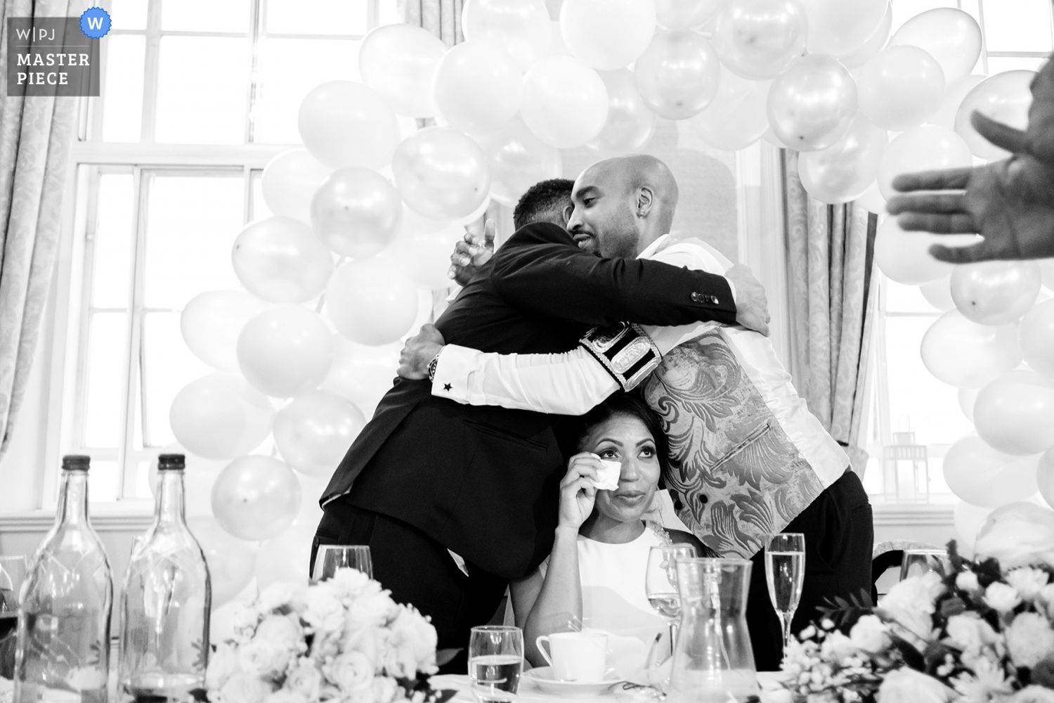 Wedding ceremony guests mingle and celebrate at an outdoor garden reception.