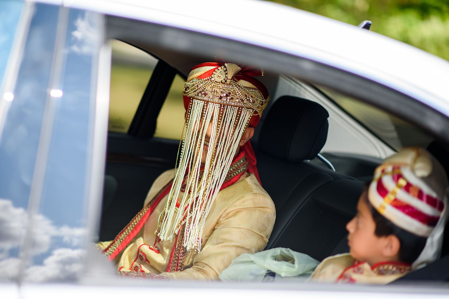 Wedding procession arriving in decorated cars with traditional ceremonial elements.
