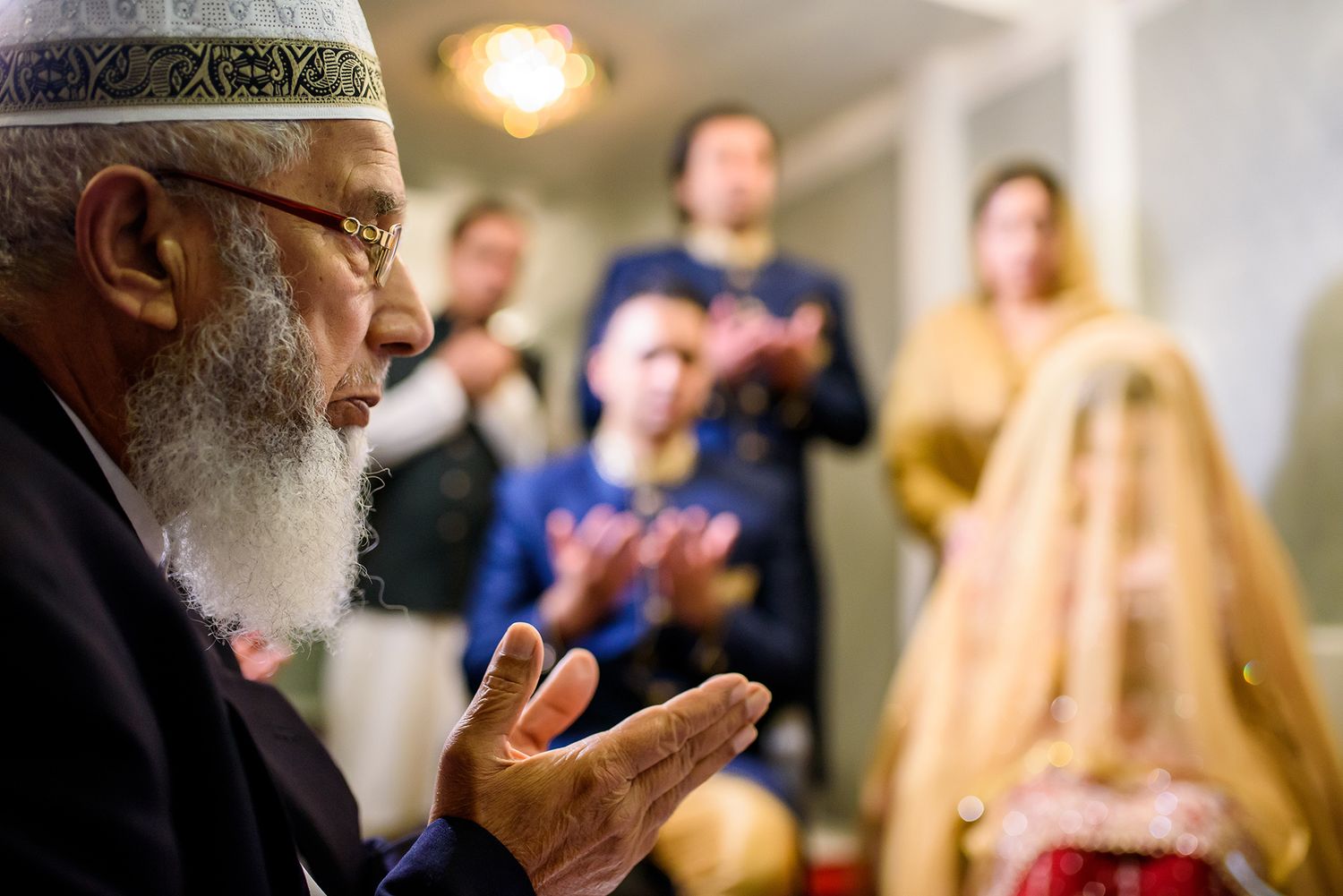 Wedding guests gathered indoors during an emotional ceremony moment.