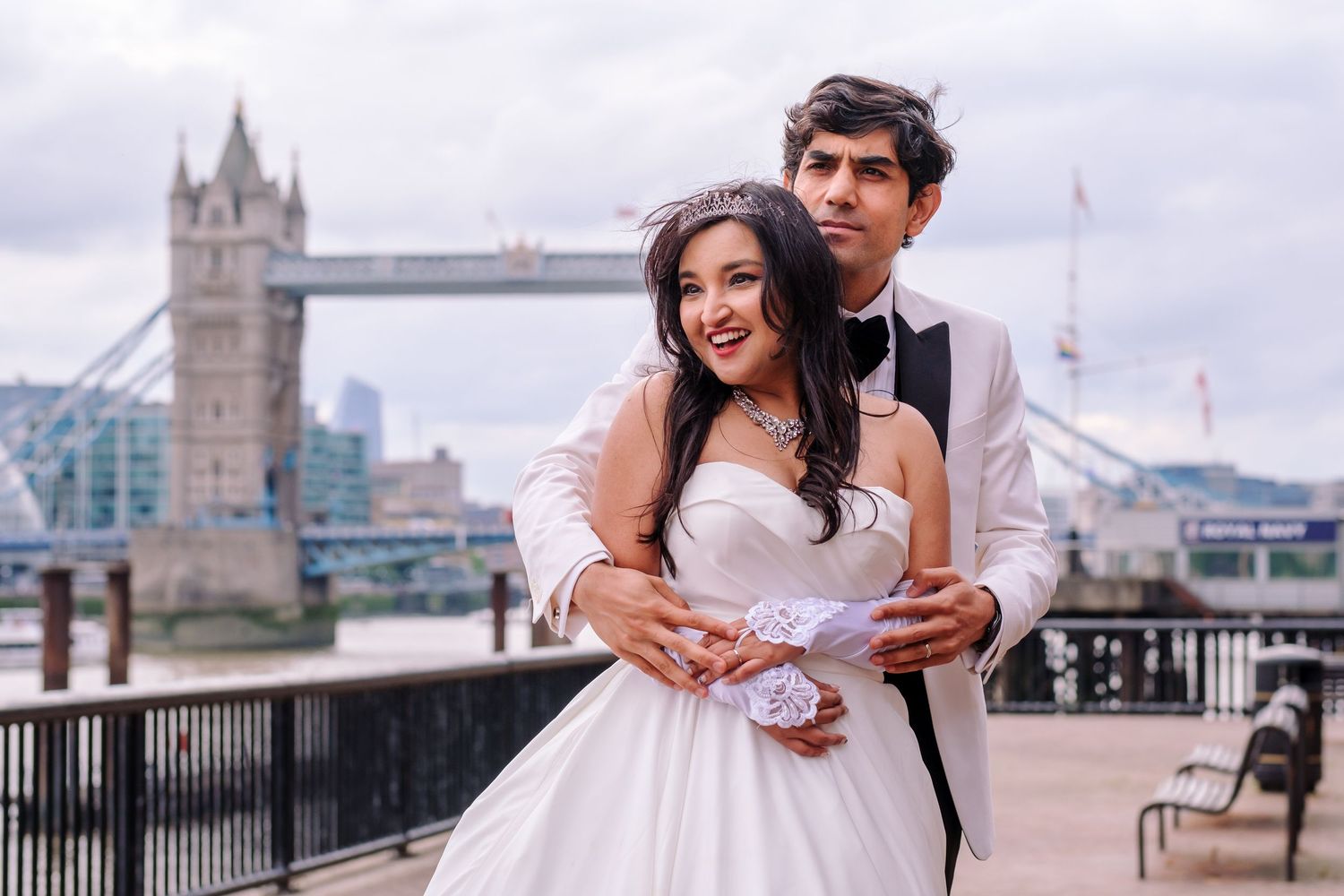 A romantic wedding portrait with London's Tower Bridge in the background.