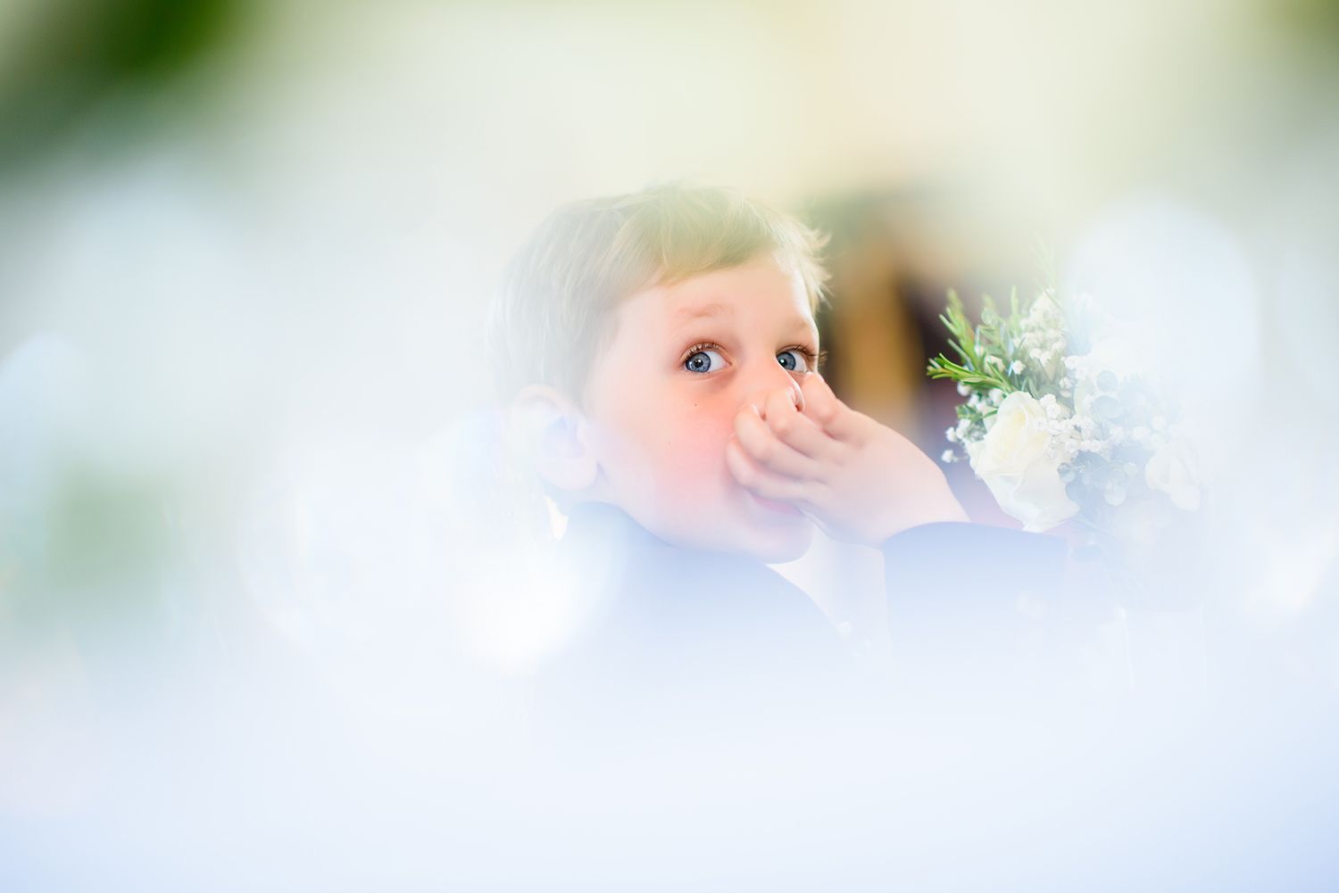 Dreamy soft focus wedding photograph through sheer fabric.