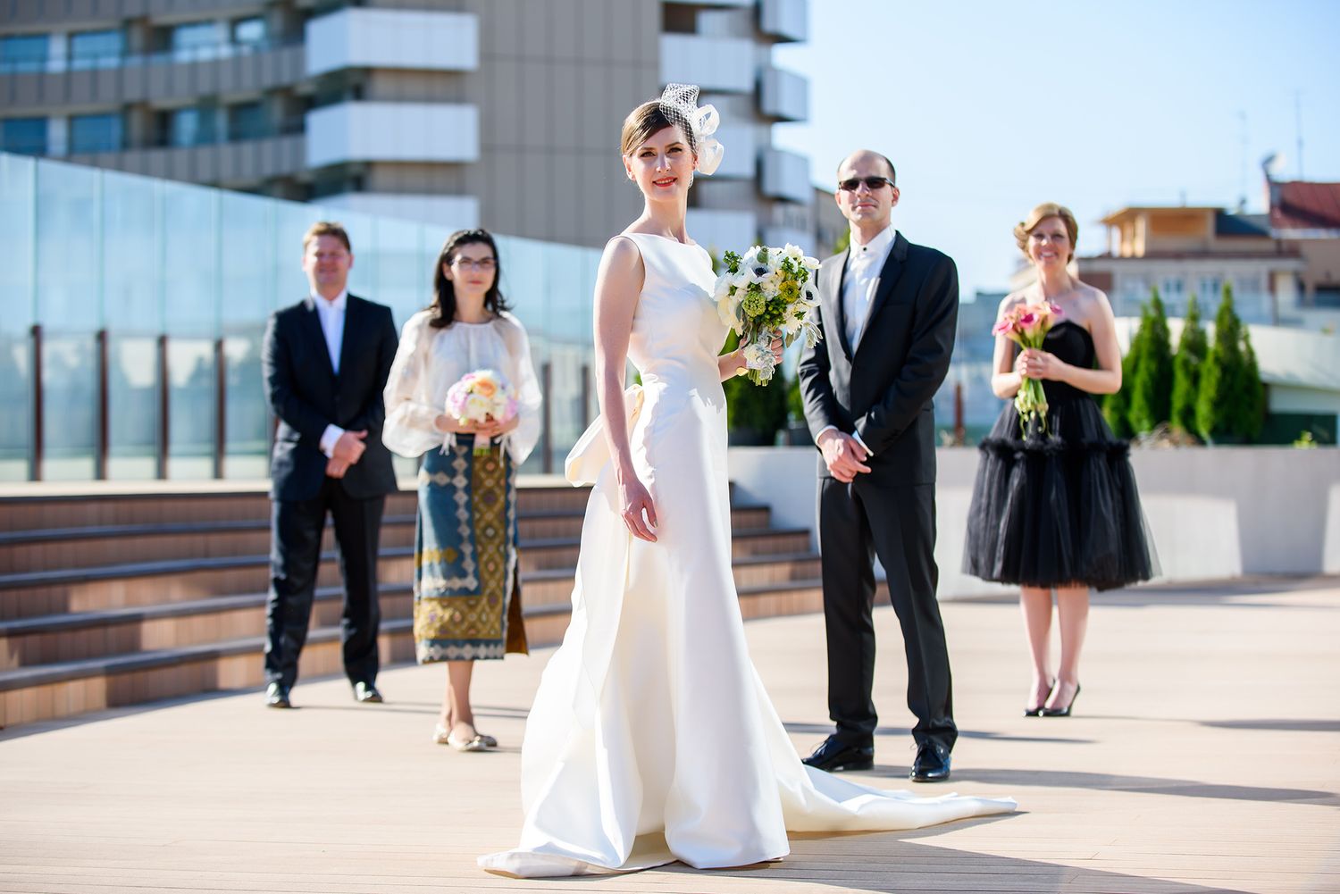 Modern rooftop wedding venue with sleek architectural elements and city views in the background.