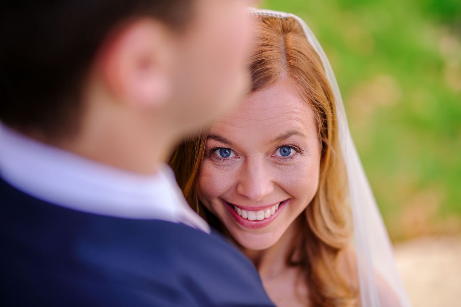 Candid wedding moments captured during an outdoor spring celebration.