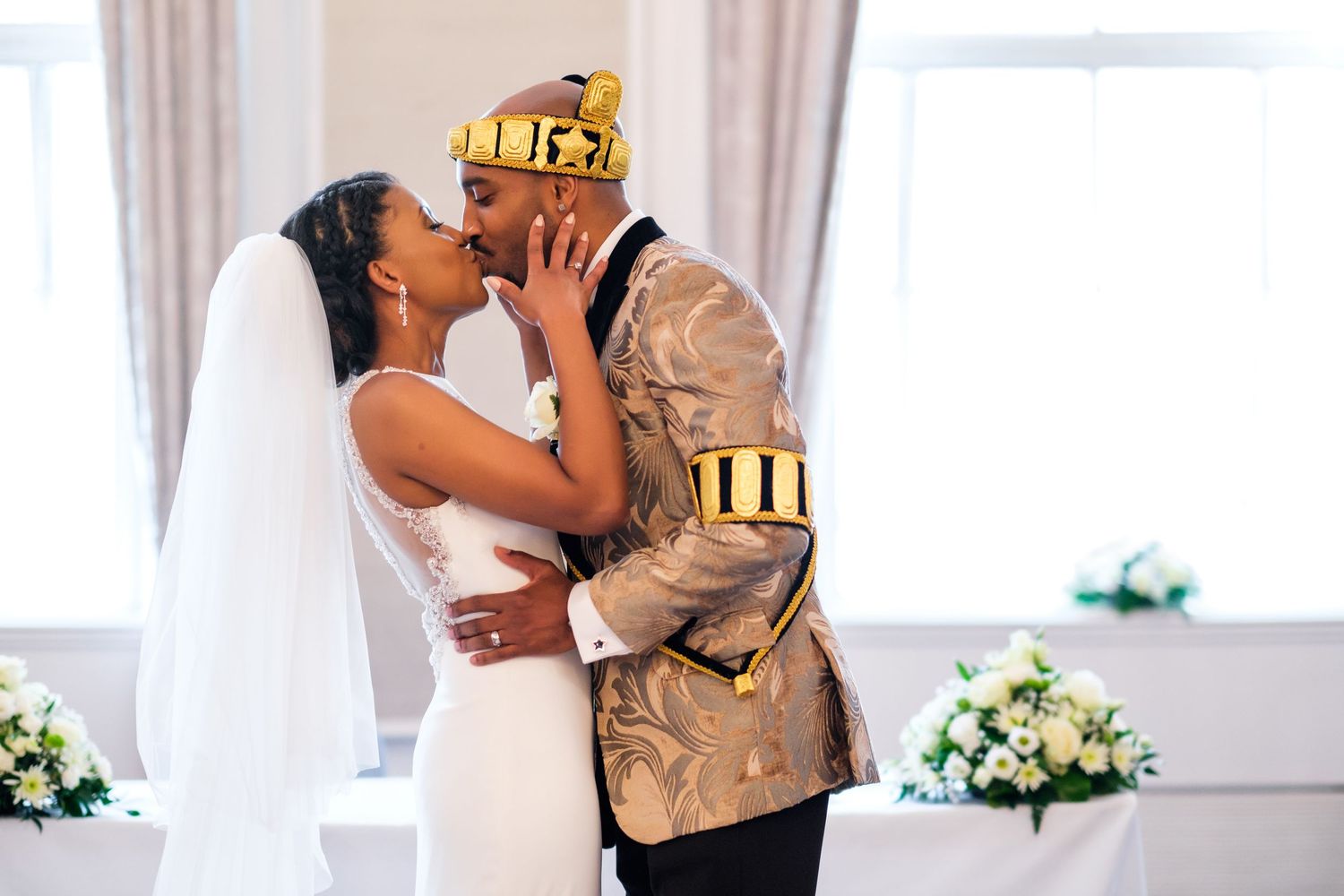 Romantic wedding ceremony moments captured in a series of intimate indoor portraits with white decor and floral arrangements.