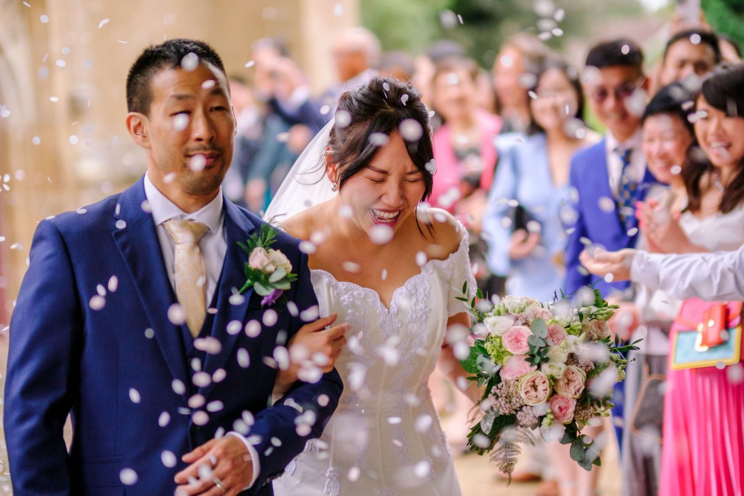 A wedding celebration montage showing joyful moments with confetti falling and guests celebrating in an outdoor setting.