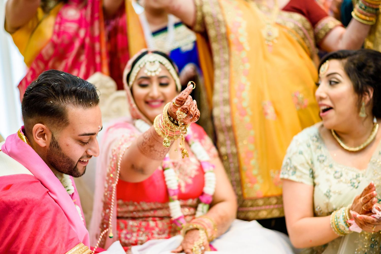 Celebratory moments from an Indian wedding ceremony with bright traditional outfits.
