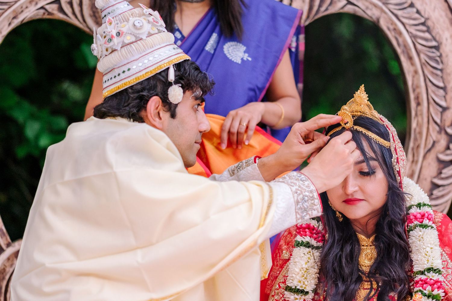 Cultural wedding ceremony with traditional attire and decorative elements in a garden setting.