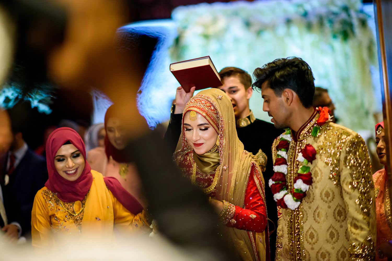 Intimate wedding ceremony moments captured with guests in traditional South Asian attire.