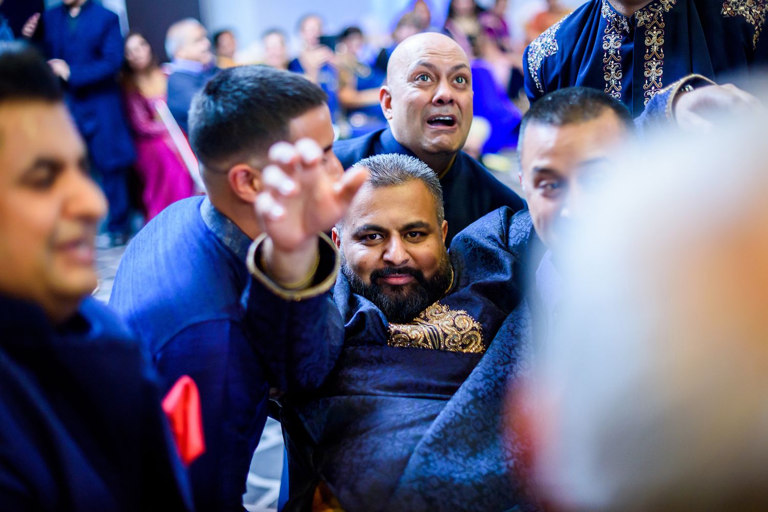 Candid moments captured during a celebration showing guests in traditional formal attire.