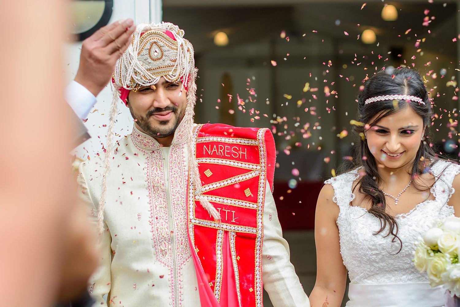 Festive wedding celebration with confetti and traditional ceremonial elements.