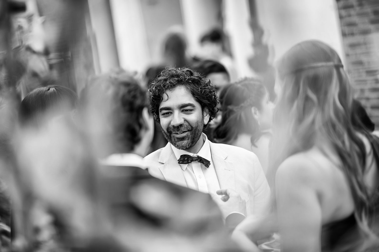 Black and white candid shot of joyful moments during the wedding celebration.