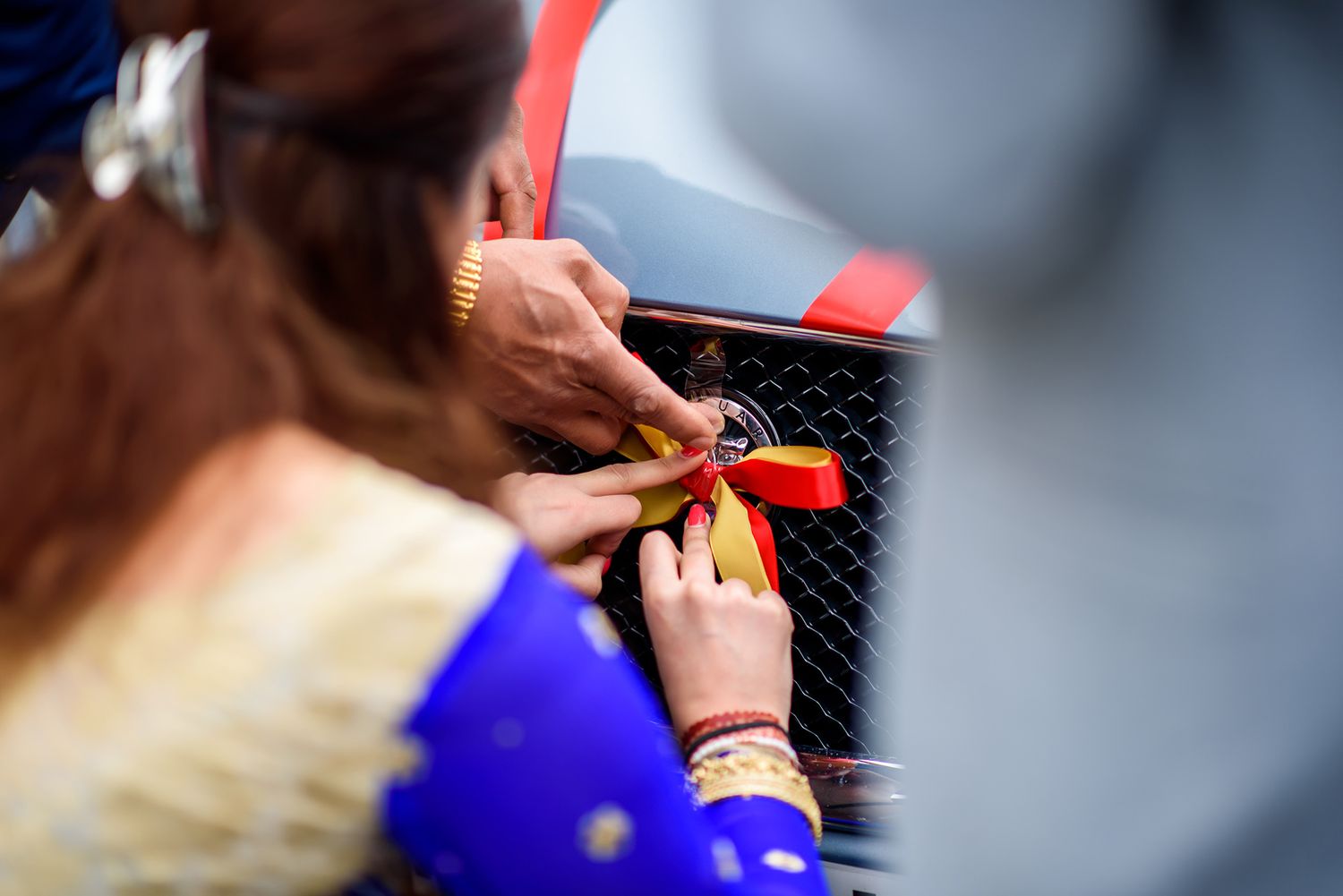 Close-up shot of hands working on mechanical details.