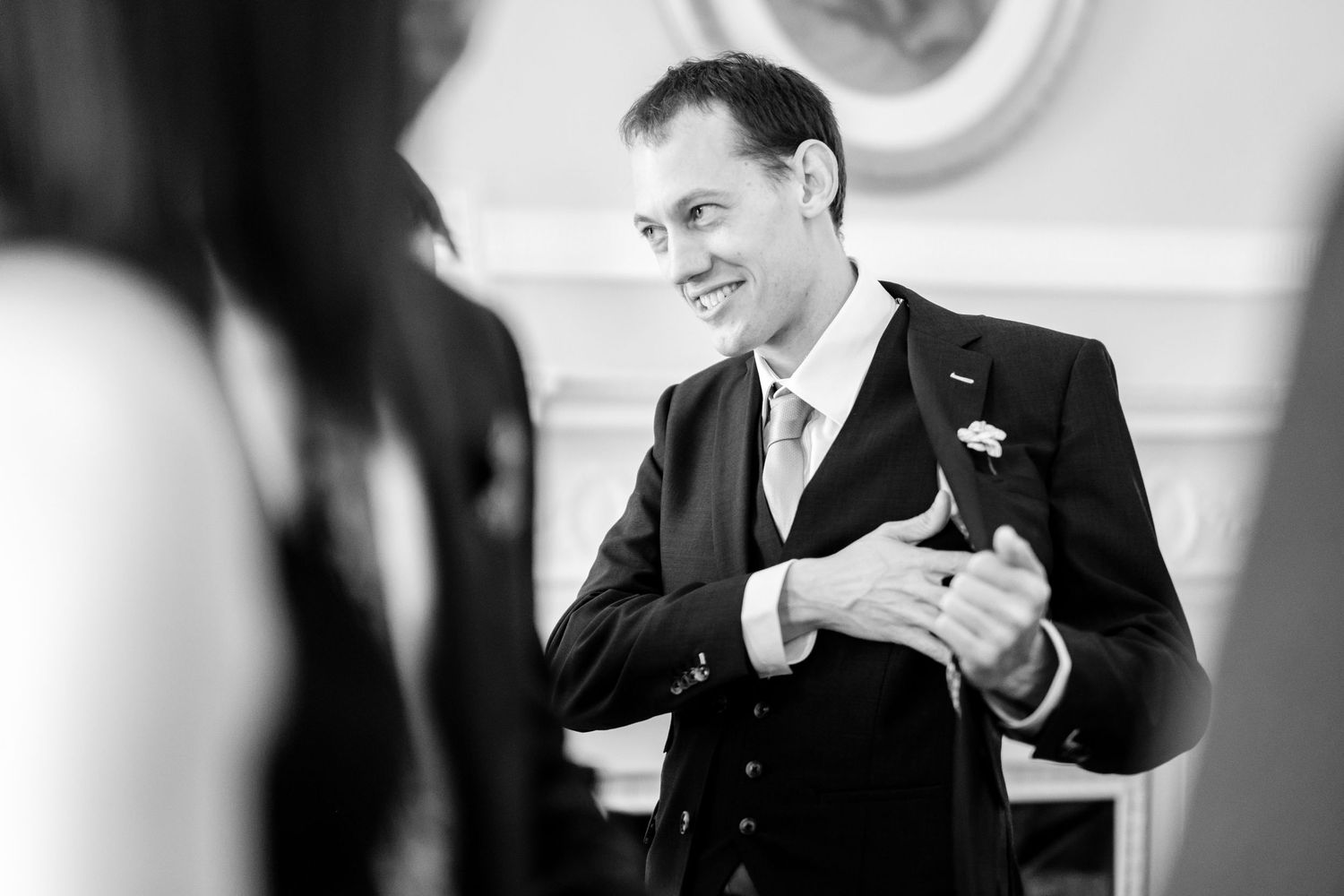 Black and white candid shots capture genuine laughter and joy at a wedding.