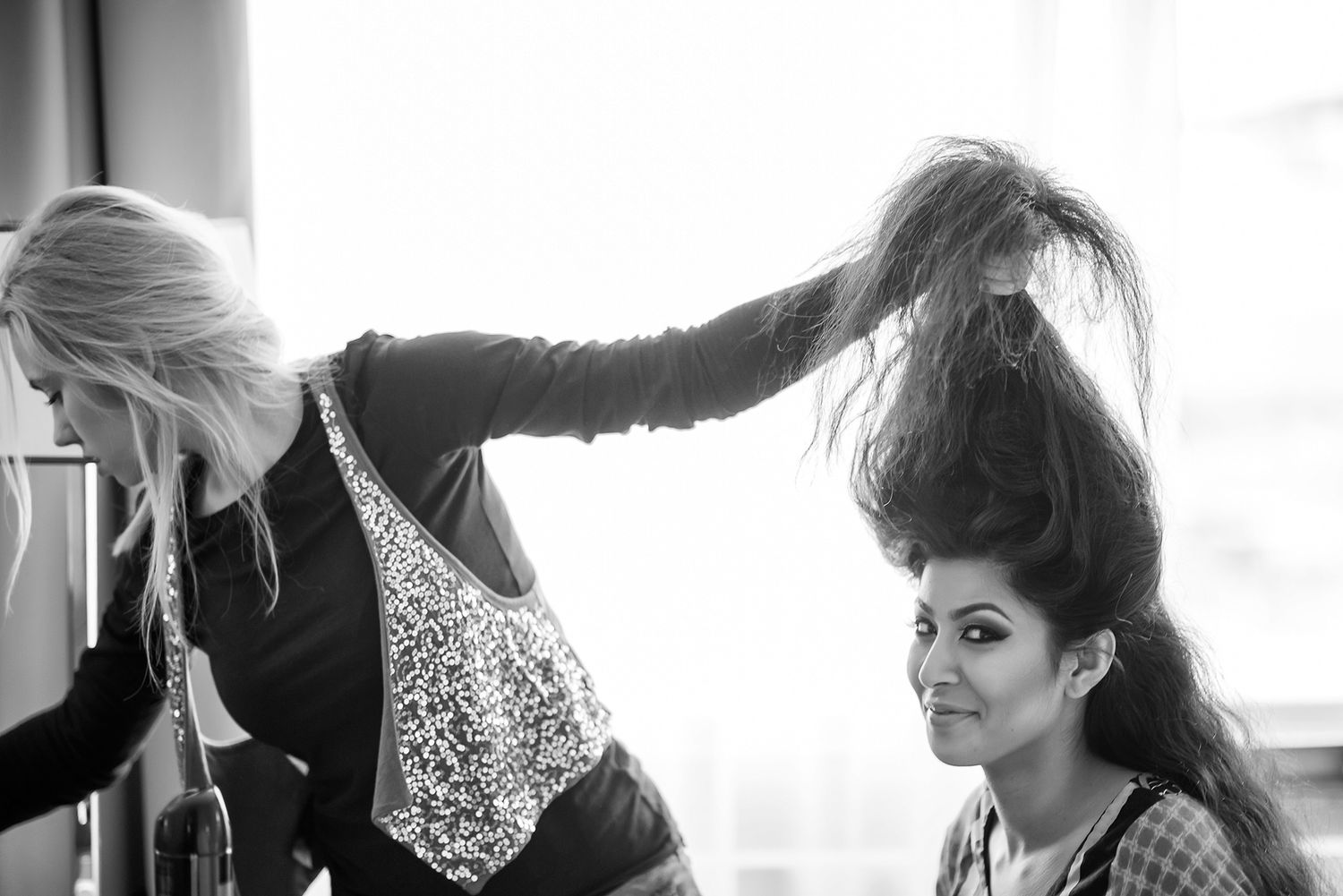 Wedding preparation moments captured in artistic black and white photography.