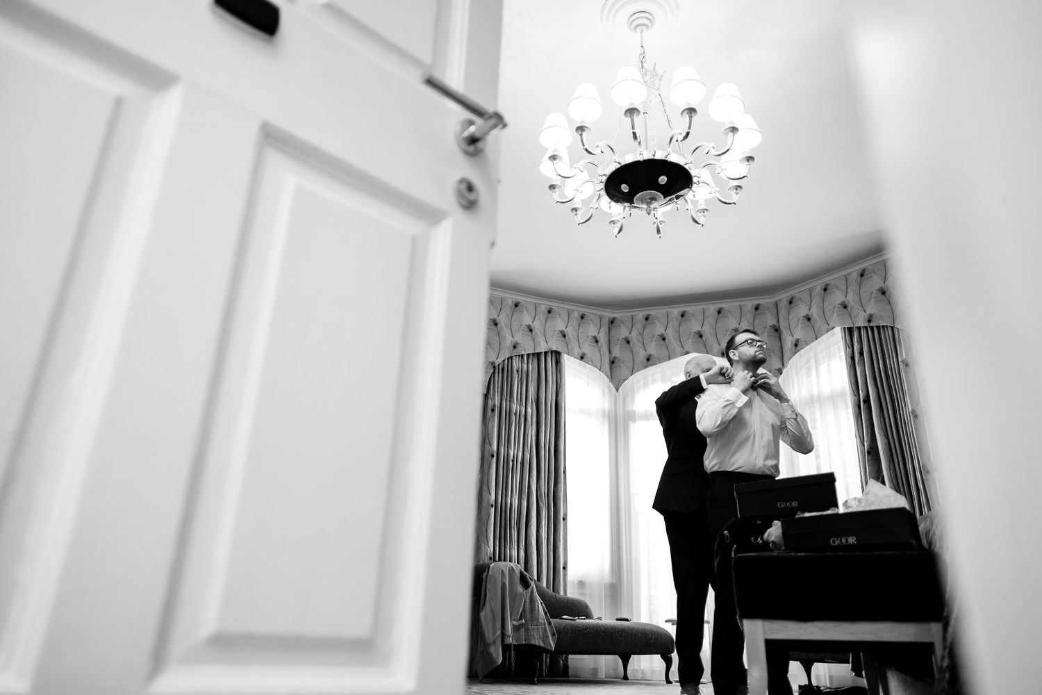 Black and white interior photos showing elegant room details with crown molding and architectural features.