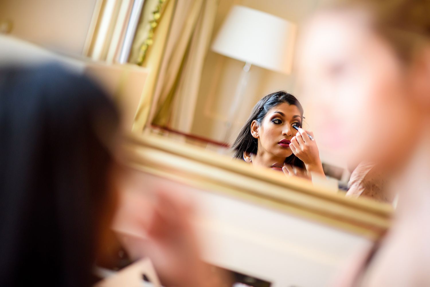 Elegant hotel room preparation scene with warm lamp lighting.