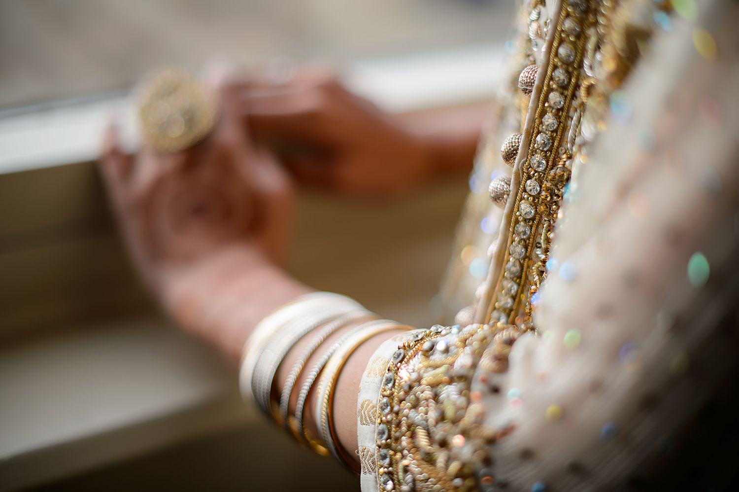 Close-up detail of intricate gold embellishments on traditional wedding attire.