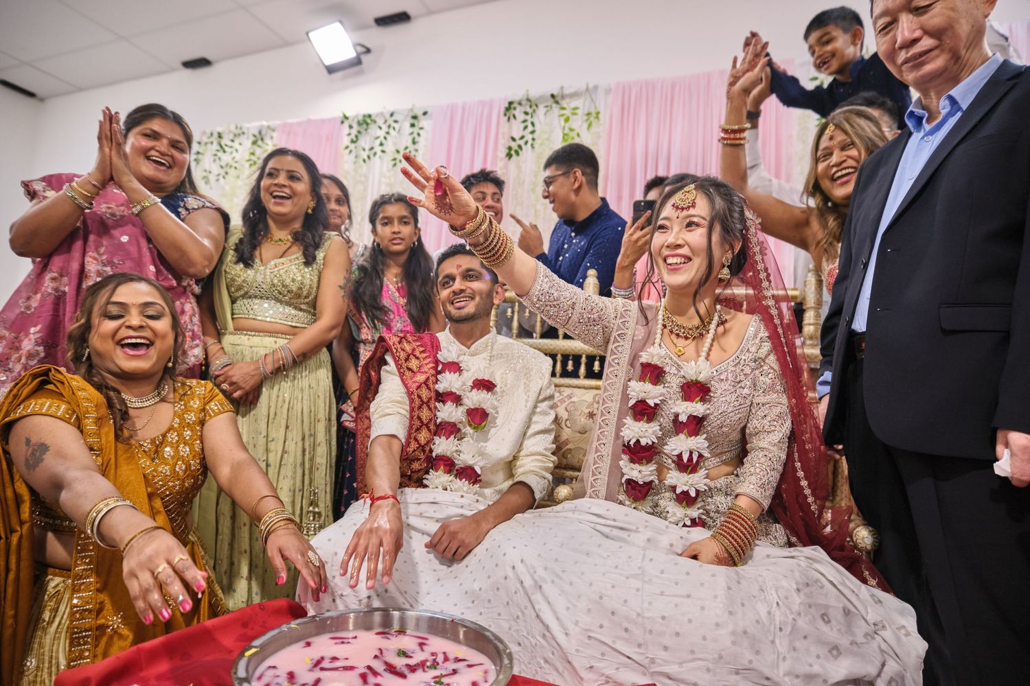 Joyful celebration at an Indian wedding reception with guests dancing and enjoying festivities.