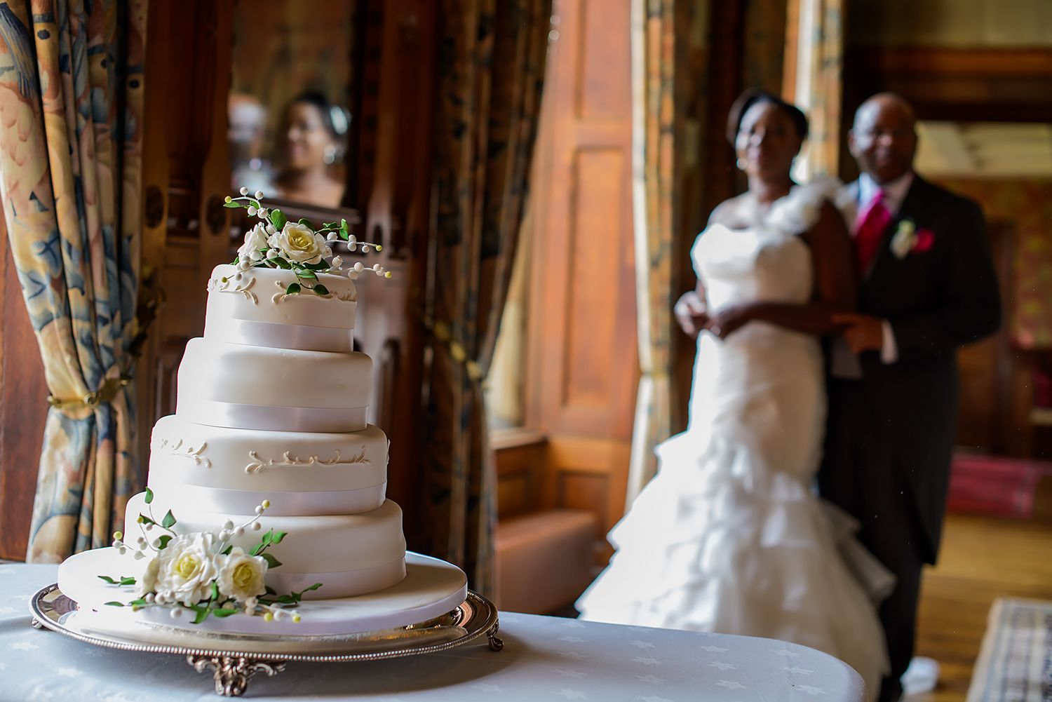 Wedding reception venue showing elegant tiered cake display and interior decor.