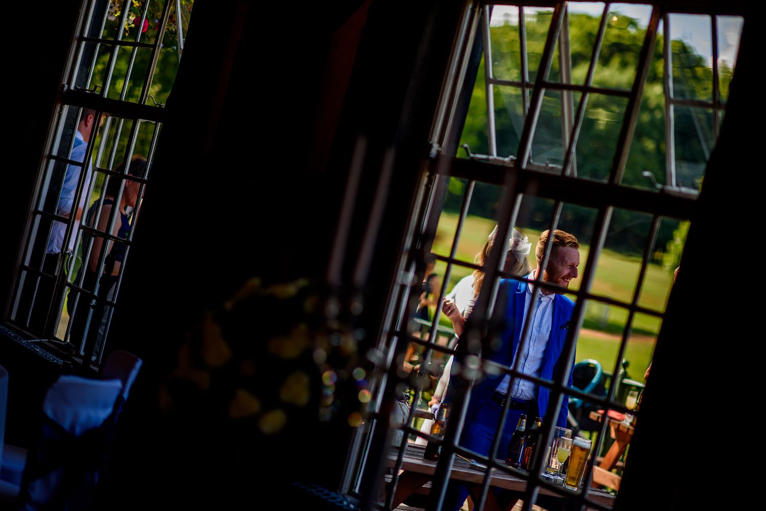 Wedding party stands in joyful laughter under beautiful natural lighting creating a candid moment.