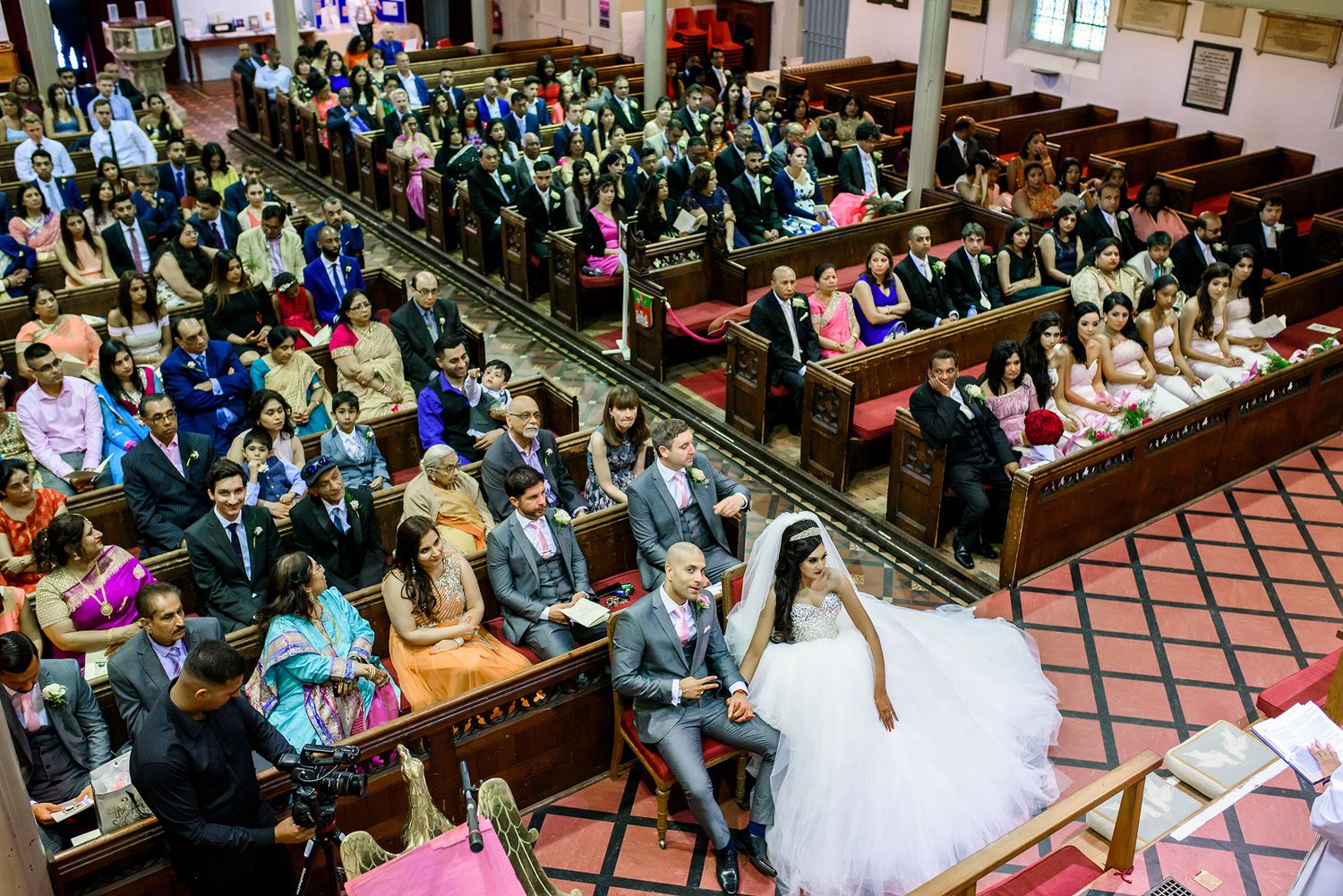 Wide view of wedding reception hall filled with celebrating guests.