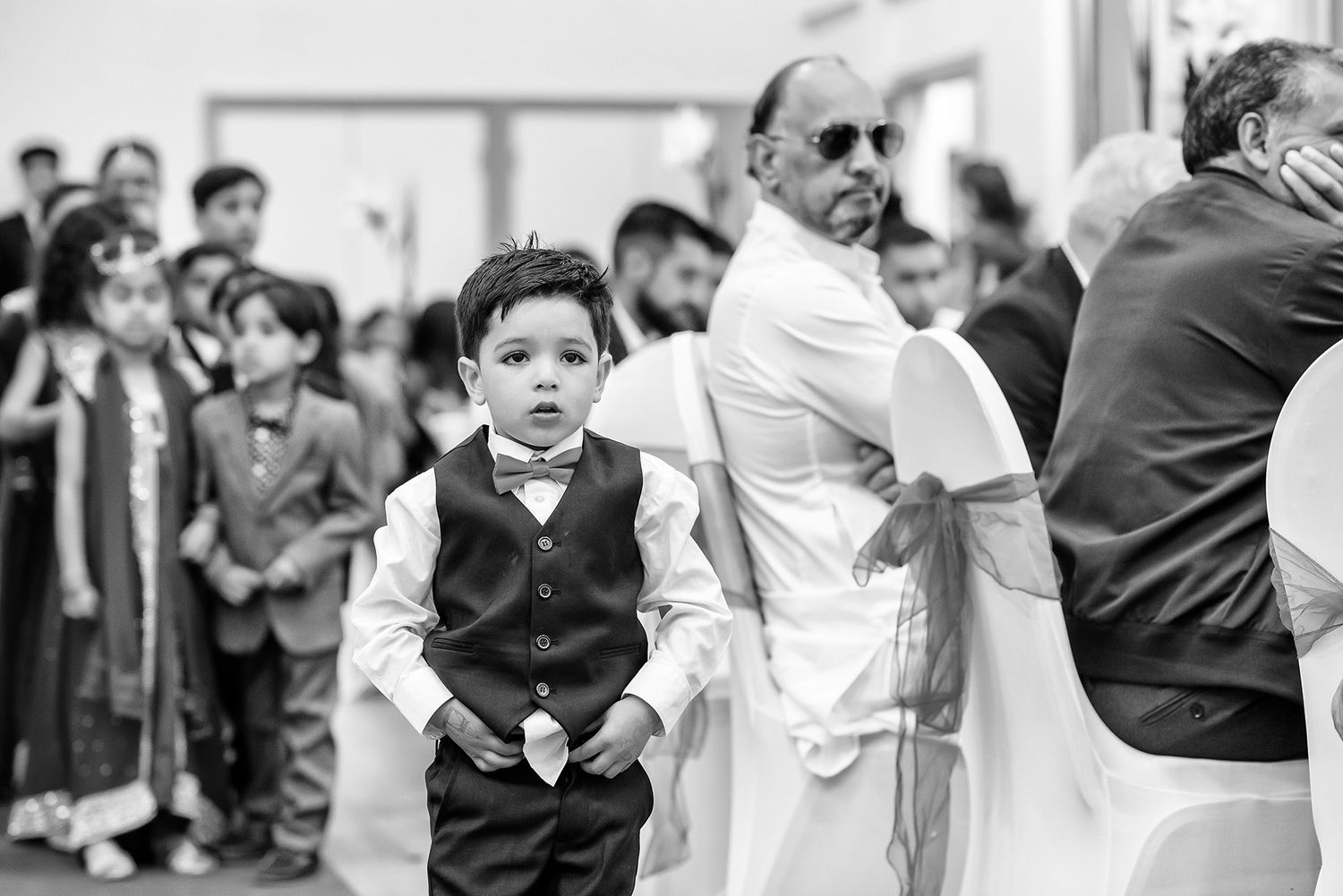 Wedding guests dressed in formal attire gathered for an outdoor celebration.