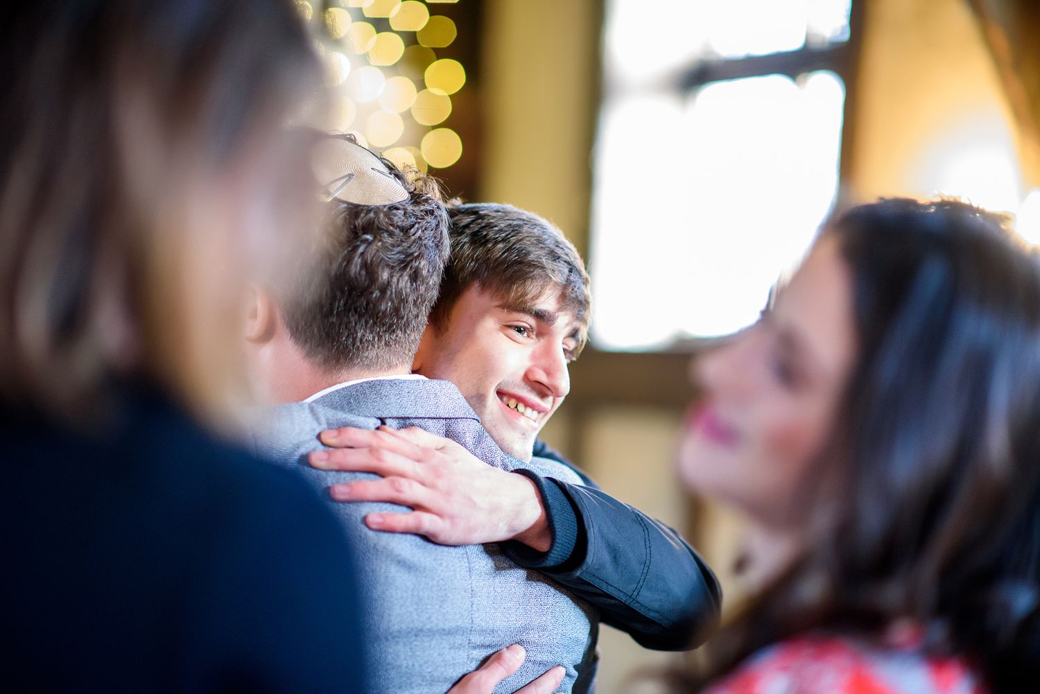 Wedding guests mingle during an indoor reception event.