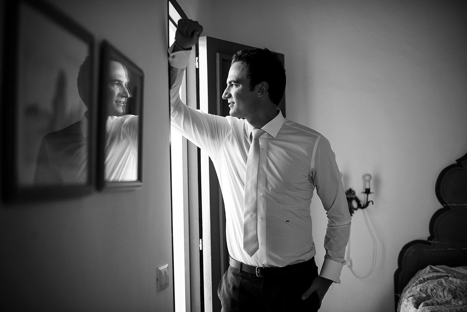 Dramatic black and white interior photography with window lighting.