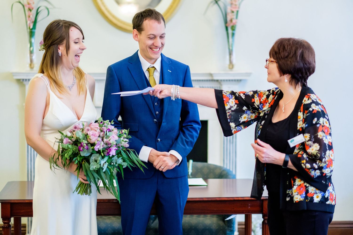 Wedding celebration with guests enjoying a casual moment in a bright indoor venue.