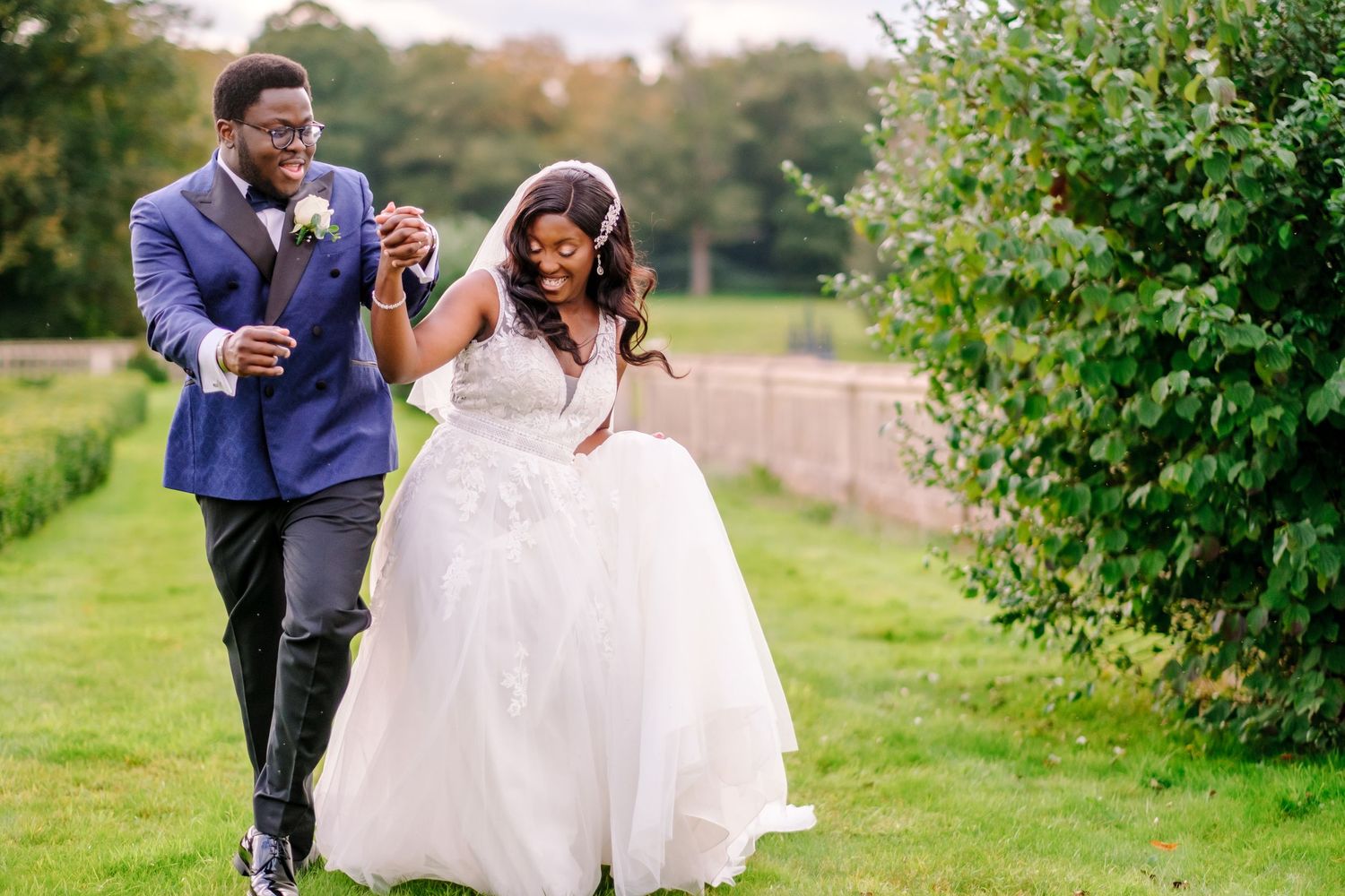Couple celebrates their wedding day with romantic portraits in a lush green garden.