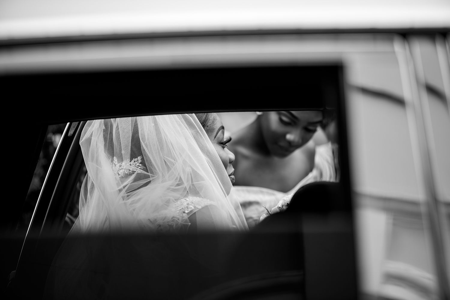 Close-up view through a car window during a wedding ceremony.