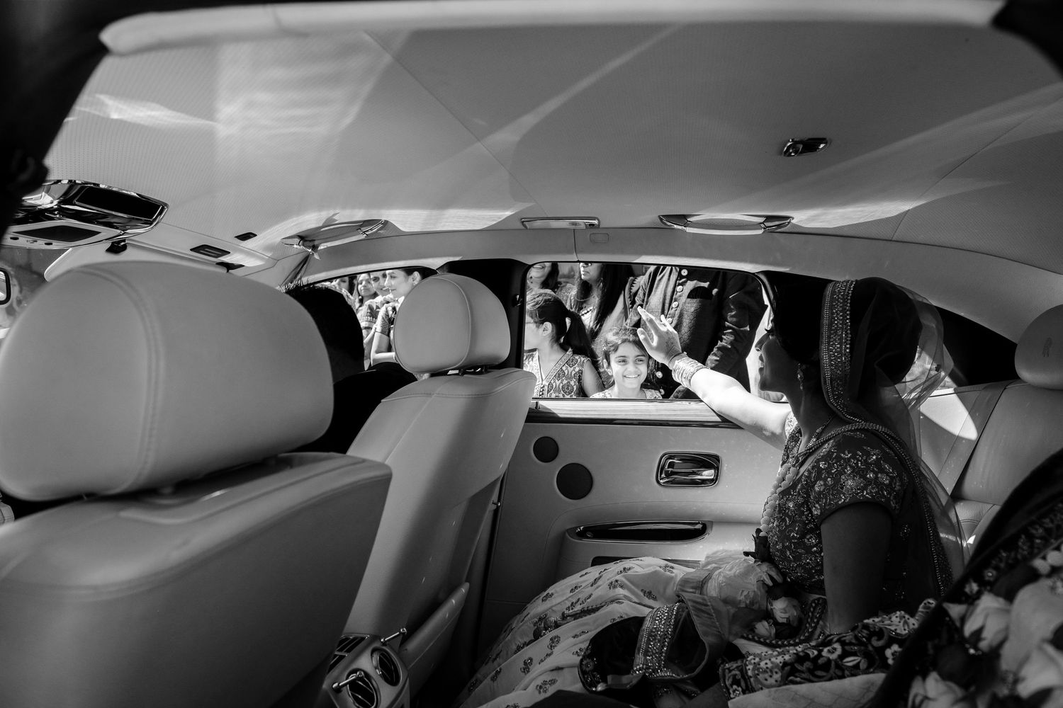 Interior view of a luxury vehicle with plush leather seating and modern amenities.