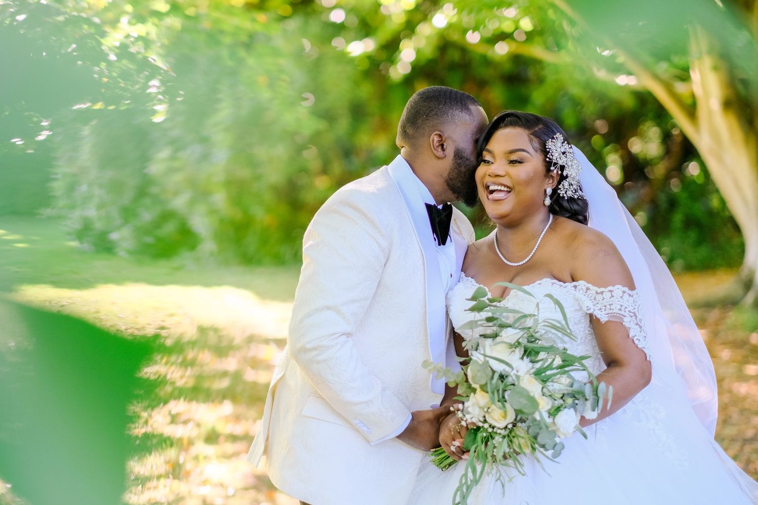 Romantic wedding portraits captured in a lush garden setting with natural lighting.