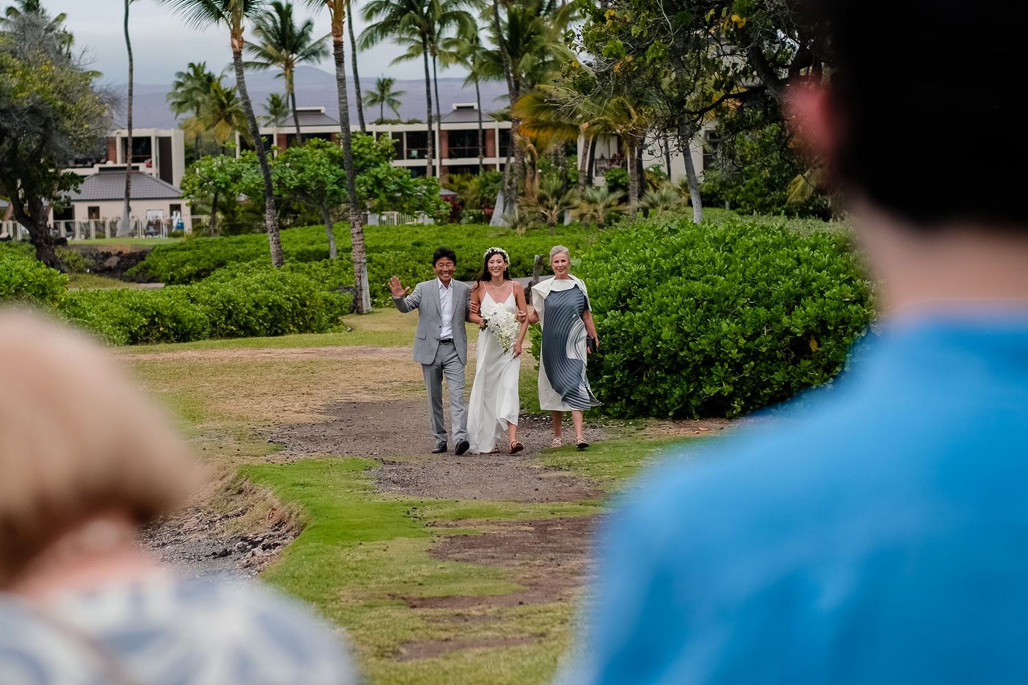 Tropical beachfront venue with palm trees and ocean views.