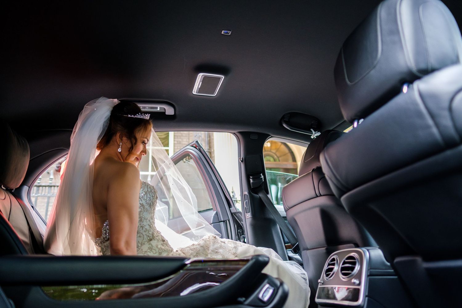 Elegant wedding day scenes photographed through car windows showing travel between venues.