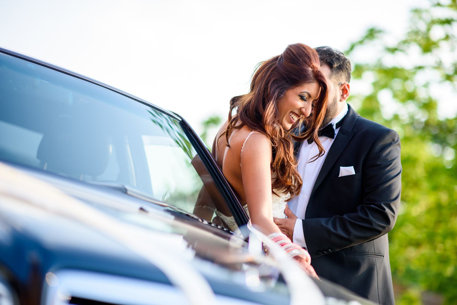 Classic wedding cars decorated with ribbons parked in a row.