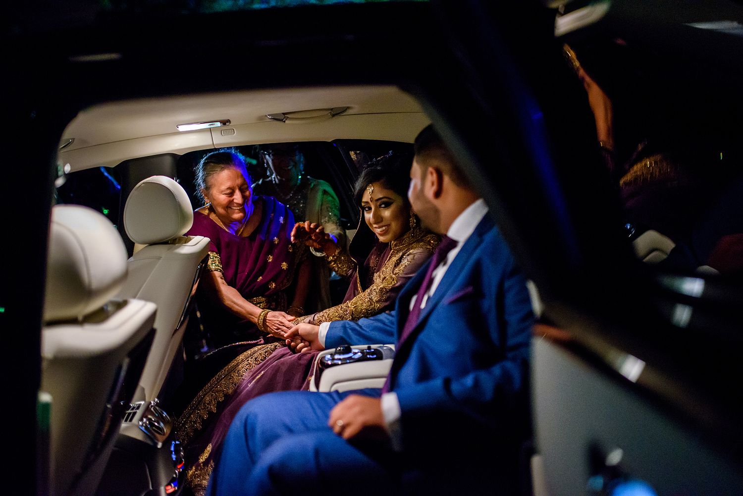 Dimly lit reception venue with guests enjoying the evening celebrations.