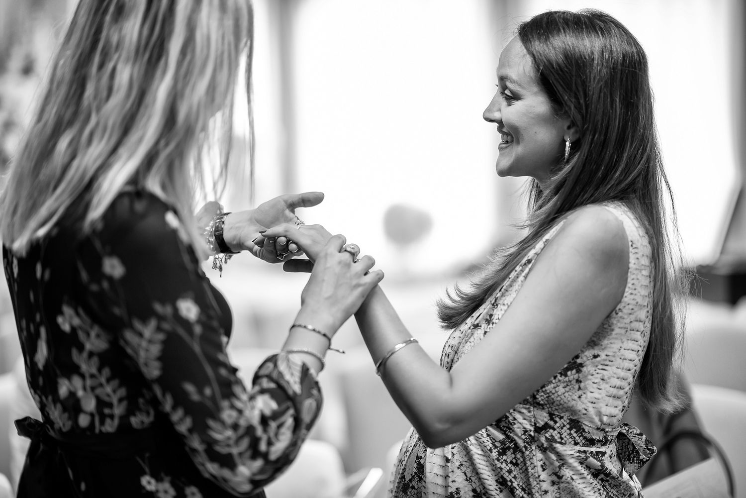 Wedding guests in formal attire captured in candid black and white photography.