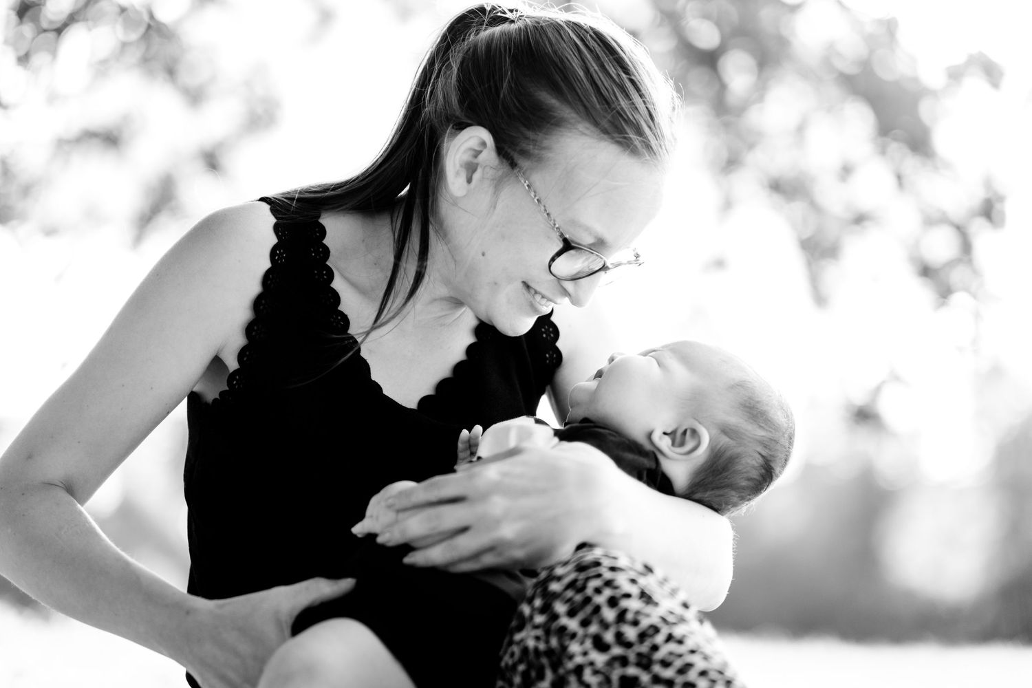 Intimate black and white portraits showing tender moments between figures.