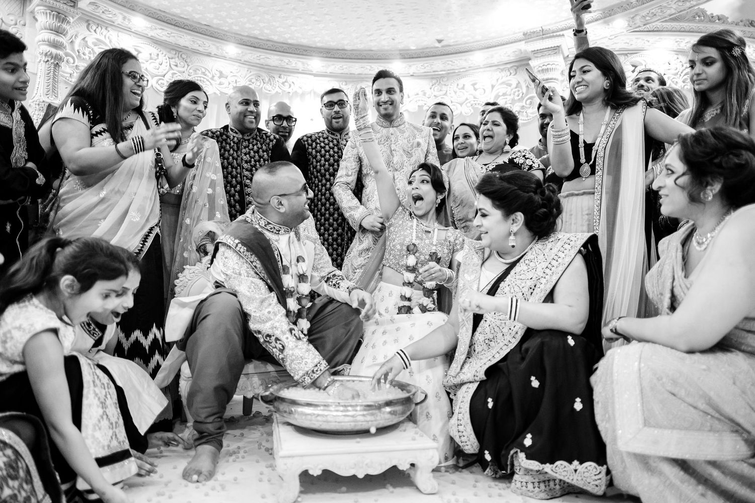 Wedding guests sharing joyful moments during a black and white photo sequence at the celebration.