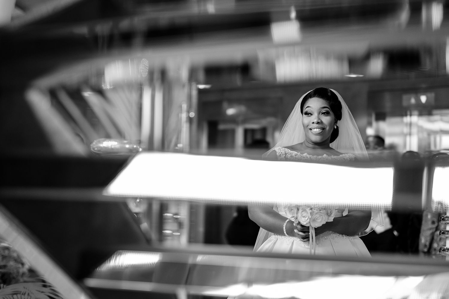 Black and white artistic bridal portrait with reflective surfaces.