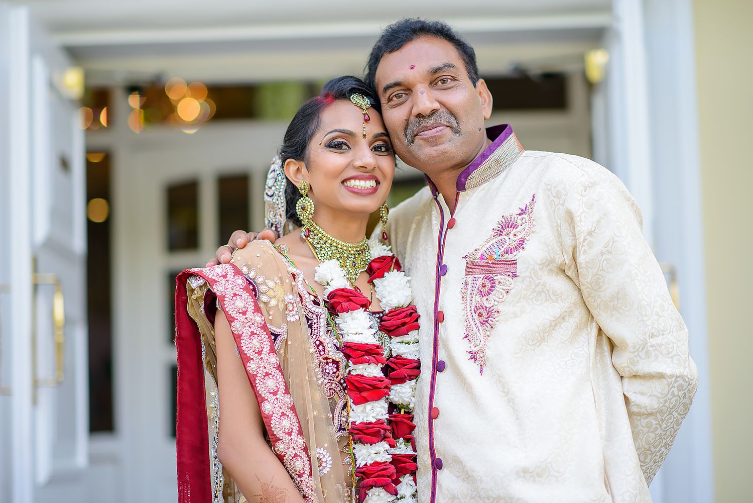 Traditional Indian wedding attire with ornate embroidery and floral garlands.