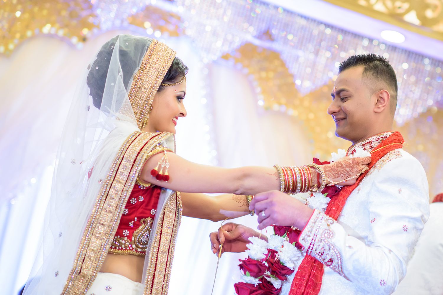 Celebratory moments during an Indian wedding ceremony with confetti and traditional attire.