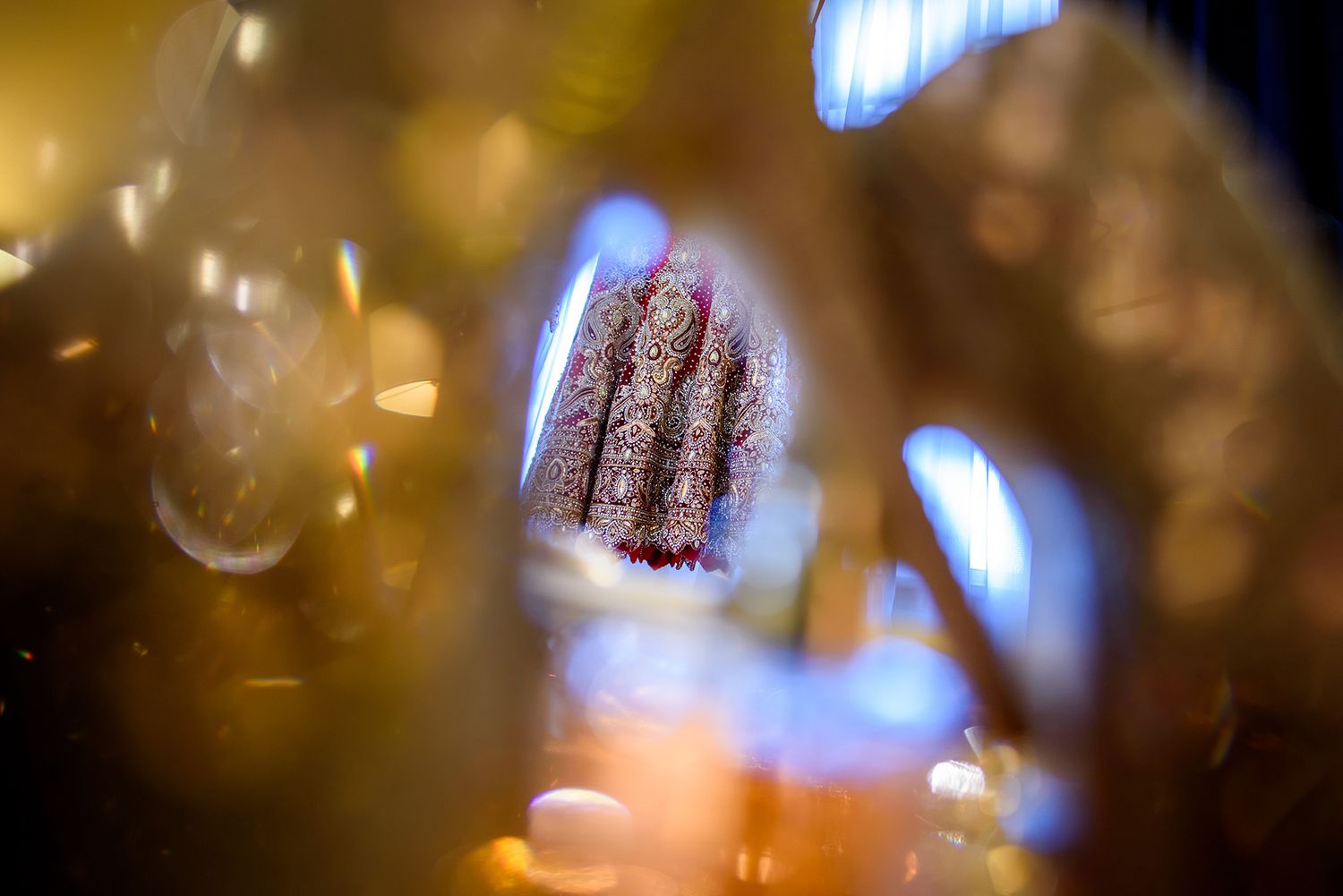 Blurred blue and gold bokeh lights create an abstract background pattern.