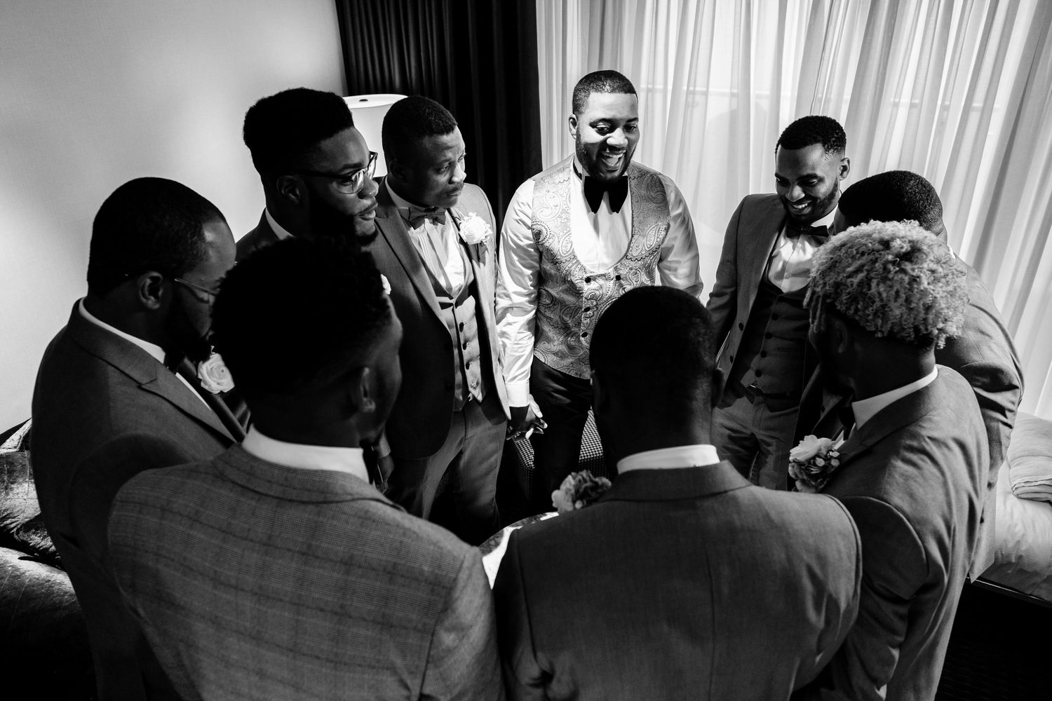 A black and white photo sequence showing people dancing and moving together at what appears to be a social gathering.