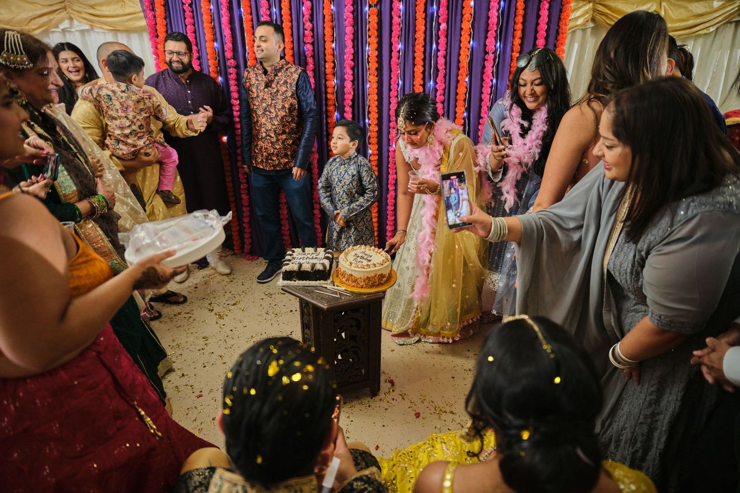 Colorful wedding celebration with guests participating in traditional Indian rituals and ceremonies.