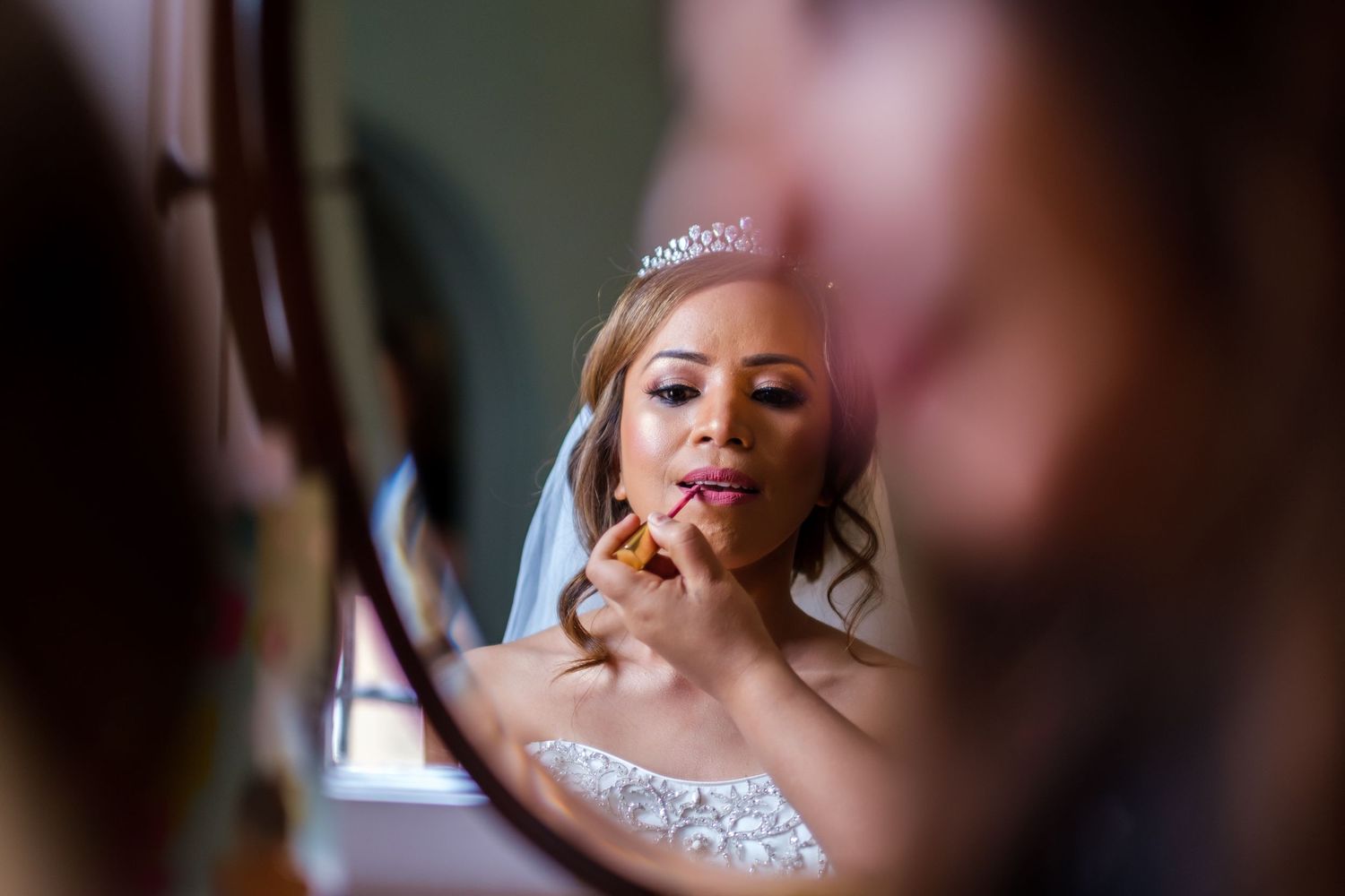 Close-up portrait shots capturing candid bridal preparation moments in soft natural light.